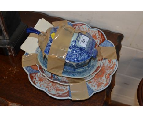 An ironstone pattern blue and white soup tureen, ladle and stand; and two Japanese Imari plates