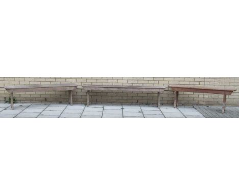 A pair of pine benches 47 x 181 x 28cm together with another pine bench 50 x 141 x 22cmProvenance:Landwade Hall, Exning, Suff