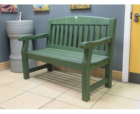 A green painted garden bench 94 x 123 x 62cmProvenance:Landwade Hall, Exning, Suffolk