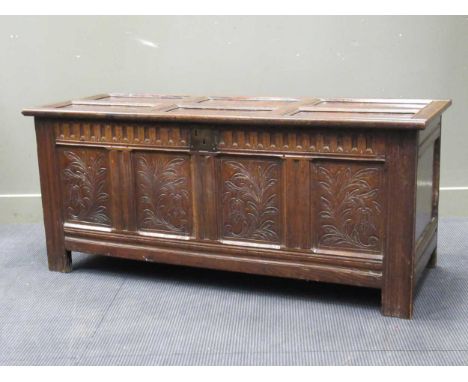 A late 17th century oak coffer, with six panel top above a carved four panel front 88 x 152 x 60cm