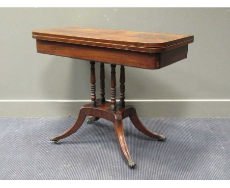 A Regency  mahogany and rosewood crossbanded card table on four turned column supports 91cm wide