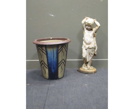 A cast iron garden statue and a glazed garden pot
