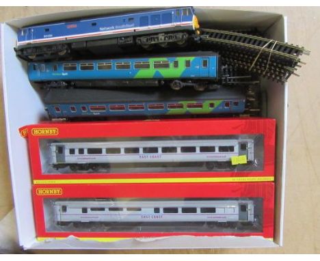 A Lima diesel locomotive, a Lima two coach diesel set, both unboxed, four Hornby boxed coaches, and various items of track an