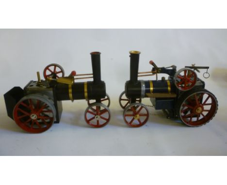 A Mamod TE1a traction engine with blue boiler and wood running boards, 8 1/2" long, and another with black boiler, 10" long (