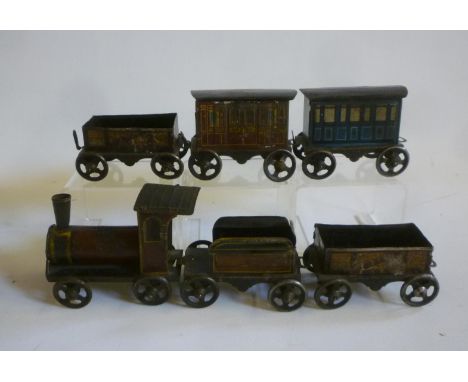 A tinplate carpet train, early 20th century, comprising locomotive, tender, two trucks and two coaches, each with four wheels