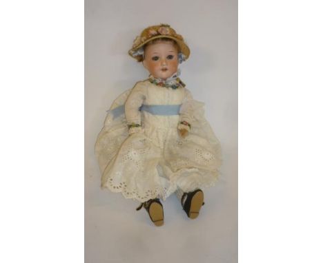 An Armand Marseille bisque head doll with fixed blue glass eyes, open mouth and teeth, light brown mohair wig, jointed compos