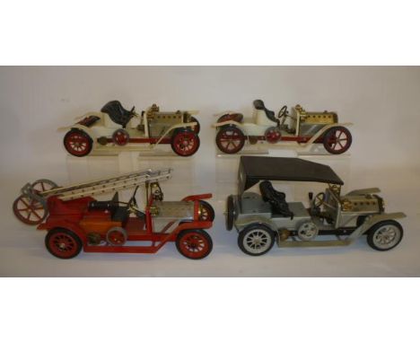 Four Mamod live steam models comprising:- Fire Engine with extending ladder, 18" long, a Tourer with soft top, 16" long, and 