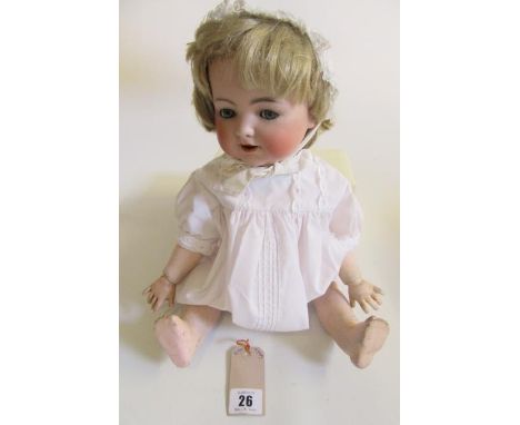 A Kammer & Reinhardt bisque head doll, with blue glass flirty/sleeping eyes, open mouth and teeth, blonde wig, jointed compos