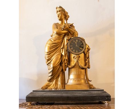 A large French clock with a Gilded lady leaning on a pillar. Set on a slate plinth. Two train French movement, striking on a 