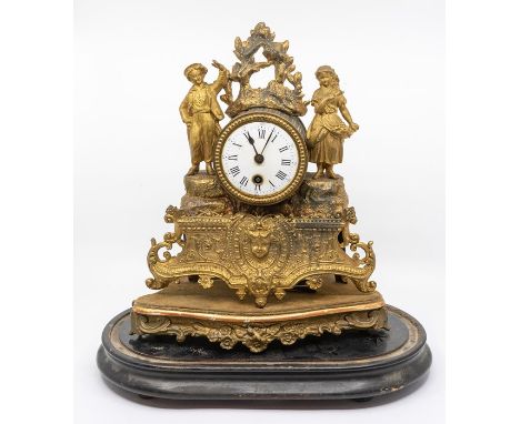 A late 19th century gilded spelter mantel clock, figural body, fitted with a white enamelled dial, black Roman numerals, comp