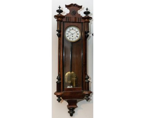 Vienna wall clock with 4” enamel two-piece dial one brass weight contained in a walnut and ebonised case 37” high.