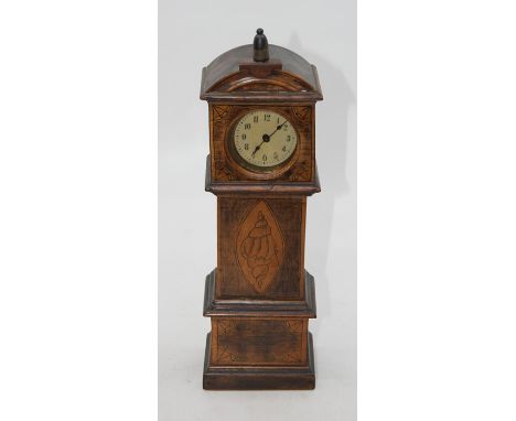 A miniature Grandfather clock/Longcase clock with small wind up movement. Shell designs on the case. Could have been an appre