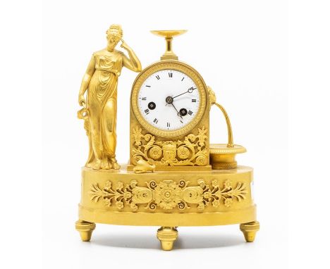 Good French Gilt mantel clock of small proportions 8” high depicting a maiden next to a water fountain. 2” dial. Two train Fr