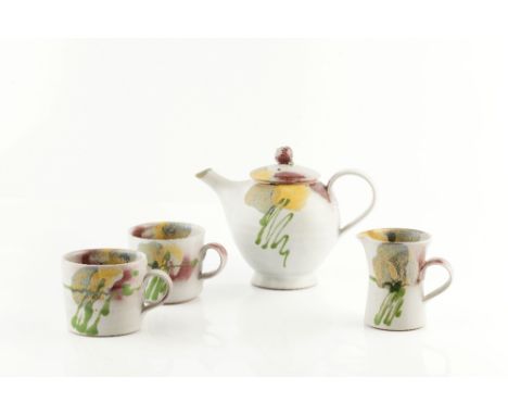 Dartington Pottery Tea set comprising teapot, milk jug, footed bowl and two cups painted with flower motifs each impressed po
