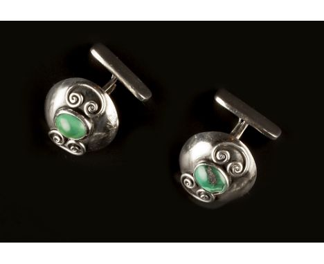 Franz Scheurle (German, fl. 1903-1970) Cufflinks each circular convex panel centred with an oval turquoise cabochon, between 