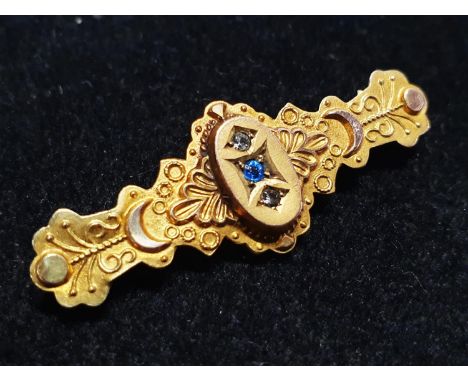 A antique 9ct gold bar brooch with sapphire and diamond decoration total weight 2g 
