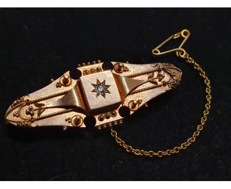 A antique 15ct gold bar brooch with gold chain and central diamond gross weight 5g 