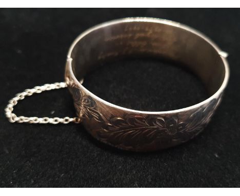 A heavy hallmarked silver bangle with dedication to inner 54g 