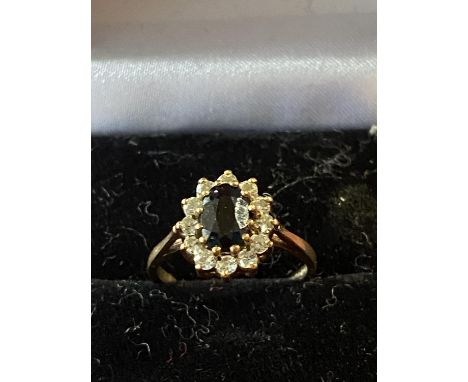 A 9ct gold central sapphire and white stone cluster ring total weight 2.11g 