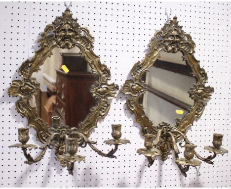 A pair of Louis XVI design brass three-light girandoles, with masked crest, 19" high overallCondition:Some scratching to the 