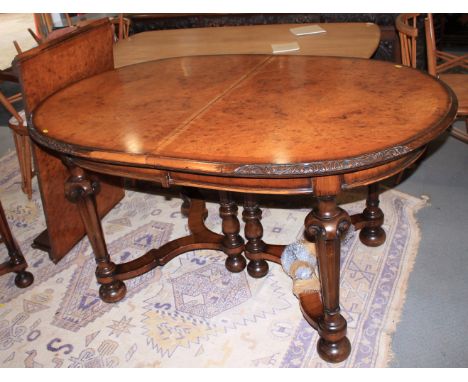 A dark walnut extending "D" end dining table, 38 1/2" x 82 1/4" when fully extended, eight matching chairs with tapestry drop