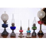 A Victorian oil lamp with etched cranberry glass reservoir and frosted shade, 26 1/2" high, and five