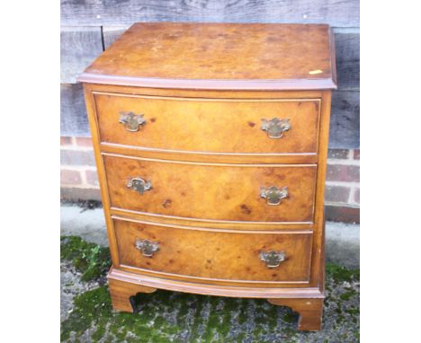 A walnut bedside chest of three graduated drawers, on bracket feet, 21" wide, two walnut shape top stools and a nest of three