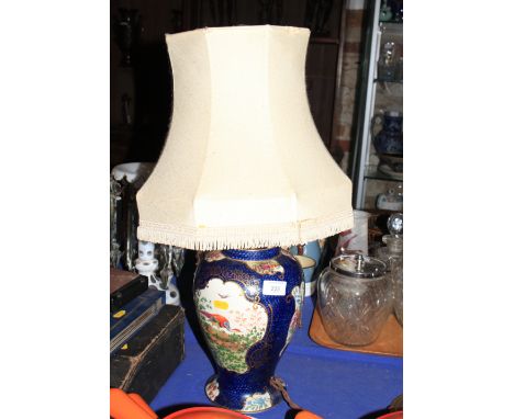 A Booths baluster-shaped lamp base, decorated birds of paradise on a blue scale ground, 11" high (restoration to base)