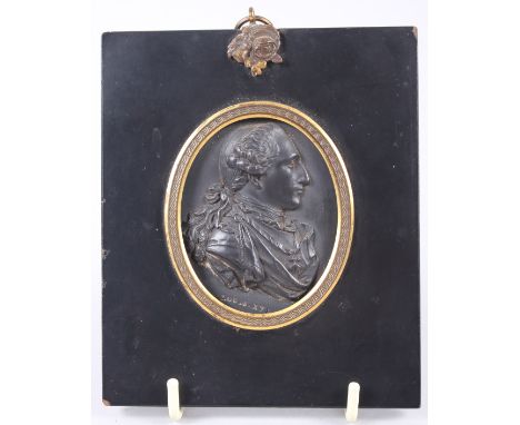 An 18th century Wedgwood & Bentley black basalt portrait medallion of Louis XVI, in ebonised and ormolu frame. Plaque dimensi