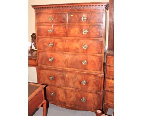 A Georgian mahogany chest on chest with banding and arched carving, fitted two short and five graduated drawers, on bracket f