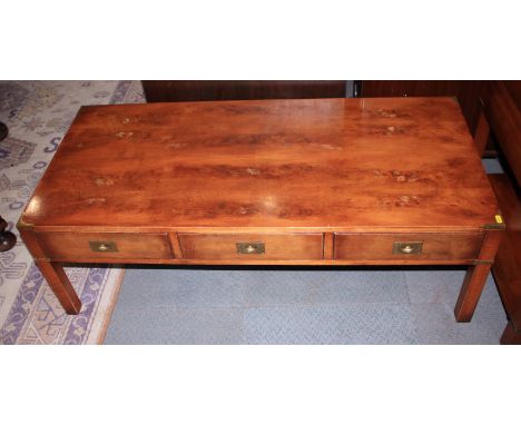 A yew coffee table with brass corners and handles, fitted three full depth drawers, and a matching lamp stand, fitted one dra