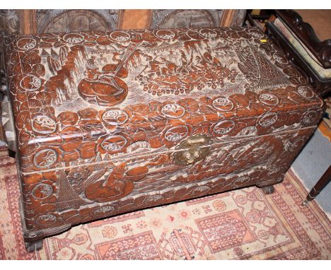 A Chinese carved camphor wood coffer, on bracket feet, 37" wide