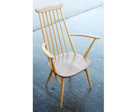 An Ercol "Goldsmith" stick back elbow chair with elm panel seat, an Arts &amp; Crafts rush seat chair and a cane seat chair