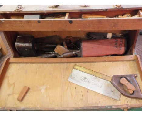 A tool box containing chisels, plane blades and woodworking tools