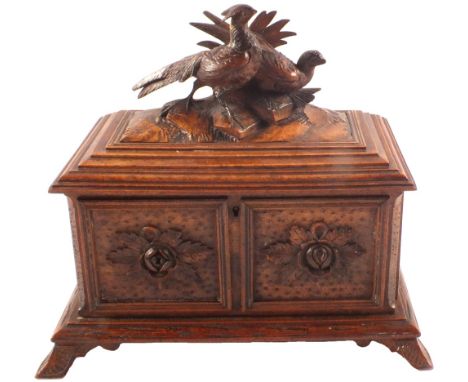 A Black Forest two compartment tea caddy with game bird finial