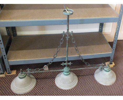A vintage style over lighting unit of three lamps on metal supports