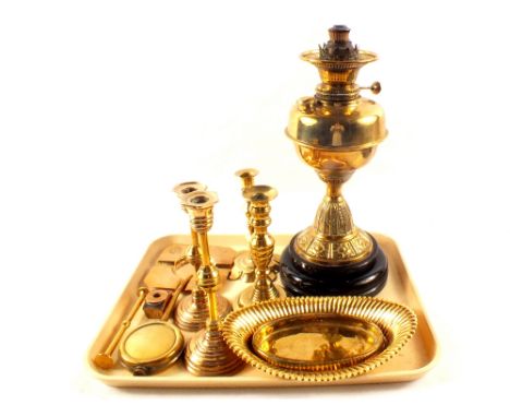 A brass oil lamp, an 18th Century petal base candlestick plus other brassware