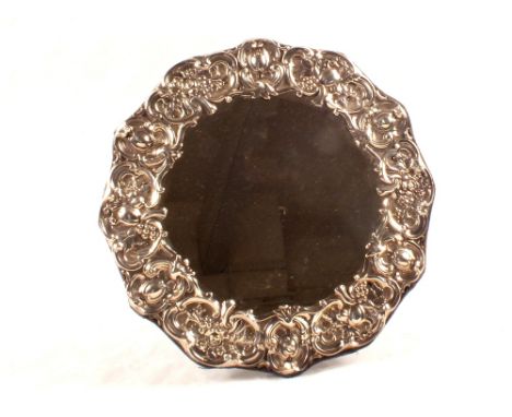 An embossed floral circular silver easel mirror, Walker & Hall, Sheffield 1907