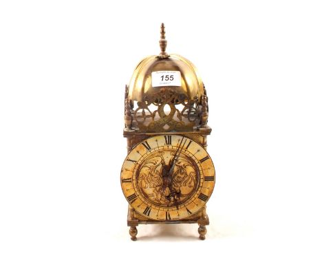 A mechanical clock in brass lantern style case
