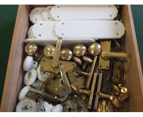 A box of brass and ceramic door furniture