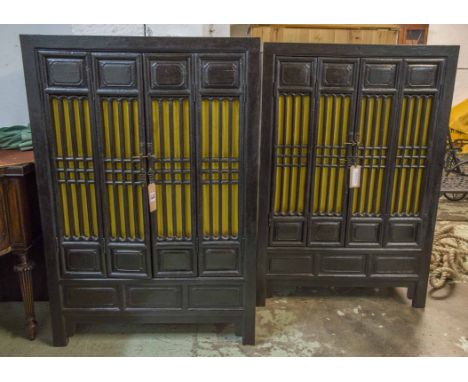 CHINESE MARRIAGE CABINETS, a pair, ebonised, each with two grilled doors enclosing a shelf and a lidded compartment for stora