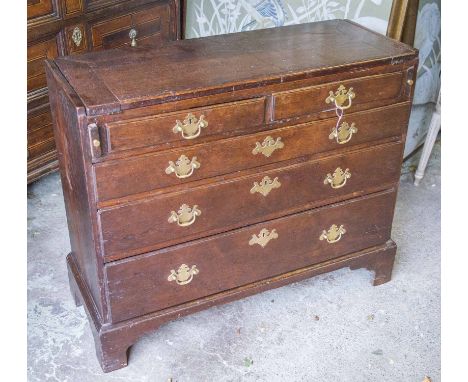 BACHELOR'S CHEST, mid 18th century George II oak, with a flip over top and two short and three long drawers raised on bracket