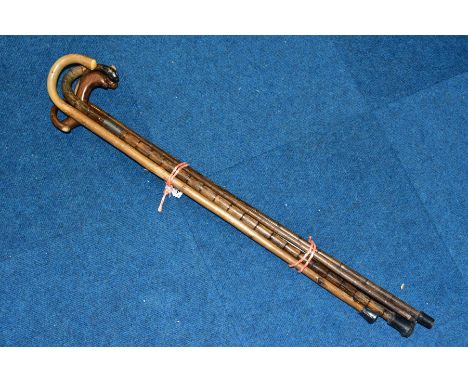 FIVE VARIOUS WALKING STICKS, to include two with silver bands and one with silver tip, longest length 92cm
