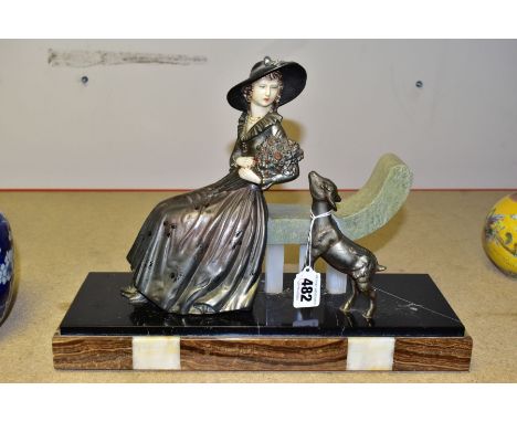 AN ART DECO SPELTER MARBLE AND CHRYSELEPHANTINE EFFECT FIGURE GROUP OF A LADY HOLDING A BOUQUET OF FLOWERS, she is seated on 