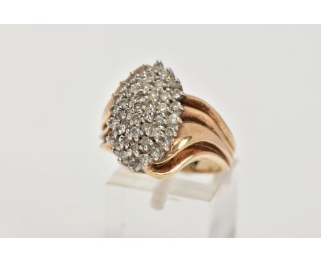A YELLOW METAL DIAMOND CLUSTER RING, the cluster of a lozenge shape, set with small round brilliant cut diamonds, total estim