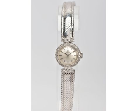 A LADY'S OMEGA 18CT GOLD AND DIAMOND WRISTWATCH, a round case measuring approximately 18mm in diameter, silver dial with bato