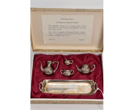 A BOXED MINIATURE SILVER FOUR PIECE TEA SET AND TRAY, each of baluster form, comprising a miniature tea pot, coffee pot, milk