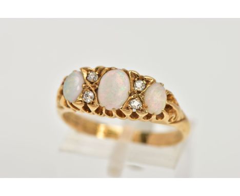 AN EARLY 20TH CENTURY OPAL AND DIAMOND RING, boat shaped design set with three graduated, oval cut opal cabochons, interspace