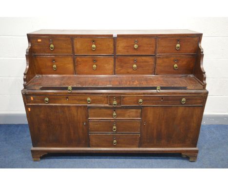 A GEORGIAN AND LATER MAHOGANY DESK, the top section with eight drawers and pull out writing slide, above a base with an arran