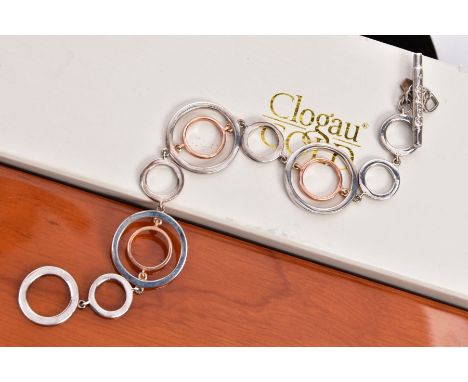 A CLOGAU SILVER AND GOLD BRACELET, openwork rose gold and silver circular links, fitted with a signed 'Clogau' toggle clasp, 